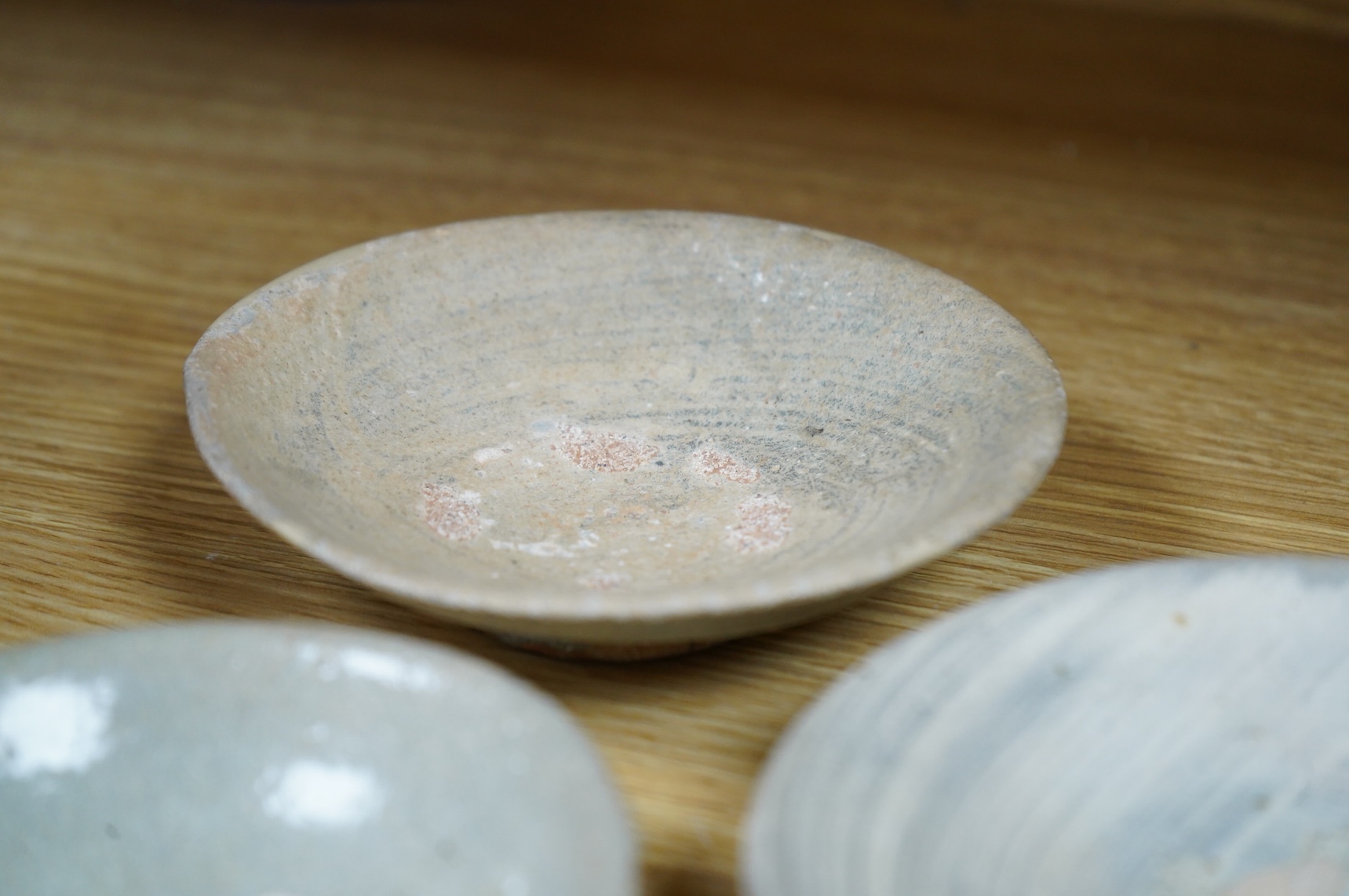 A Korean celadon dish and two Korean Pongchong dishes, Goryeo dynasty, largest 13cm